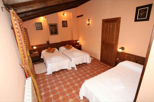 a hotel room with two beds and a room with at Casa Rural Calderon de Medina III in Siete Iglesias de Trabancos