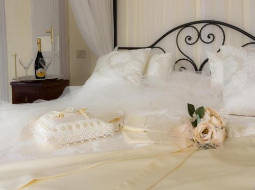 a white bed with a wedding dress on it at Casa Isabella B&B in Rocca San Giovanni
