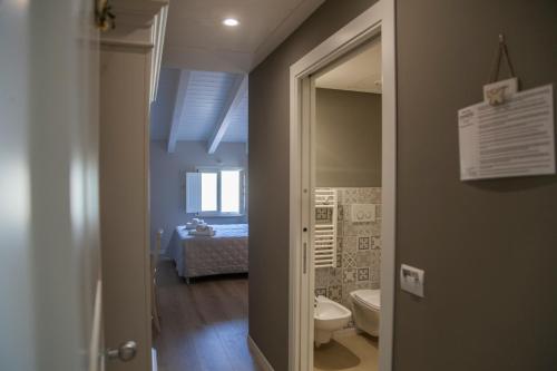 a bathroom with a toilet and a sink in a room at Tenuta Danesi - Camere - Appartamenti - Bubble Room in Matera