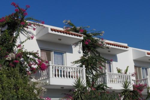 a white building with flowers on the balconies at Castle View Apartments in Haraki