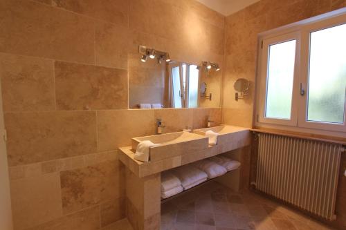 a large bathroom with a sink and a mirror at Aux charmes de grasse in Grasse