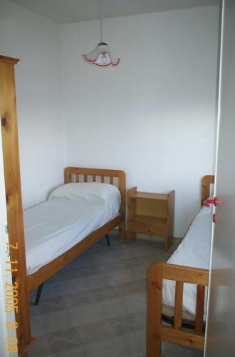 マリーナ・ディ・ペスコルーゼにあるcasa posto cantoro 1の二段ベッド2台とナイトスタンドが備わる客室です。