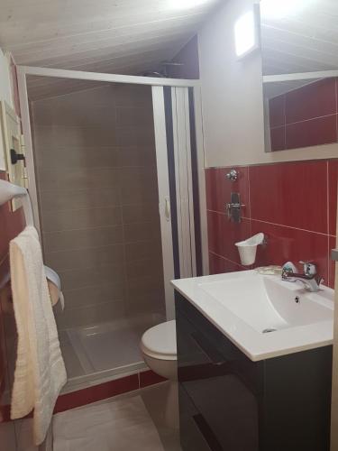 a bathroom with a sink and a toilet and a shower at Casa Anna Maria in Marsala