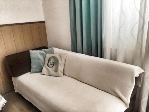 a white couch with two pillows on top of it at Apartment Marija in Selce