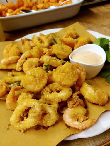 a plate of shrimp with a bowl of dipping sauce at Hotel Locanda Al Sole in Castello di Godego