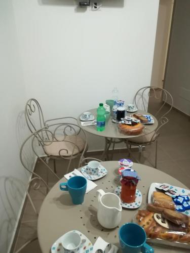 two tables with plates of food and drinks on them at Il Covo delle Civette in Vietri sul Mare