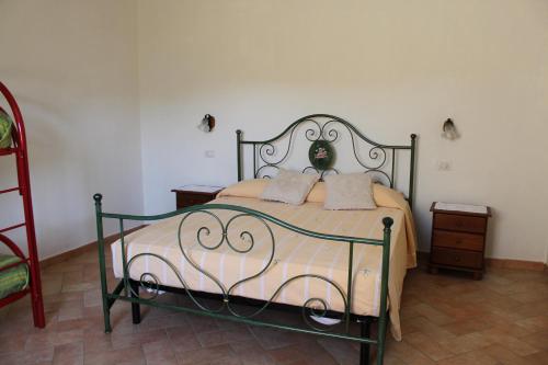 a bedroom with a bed with a metal frame at Il Nasciolo in Arrone
