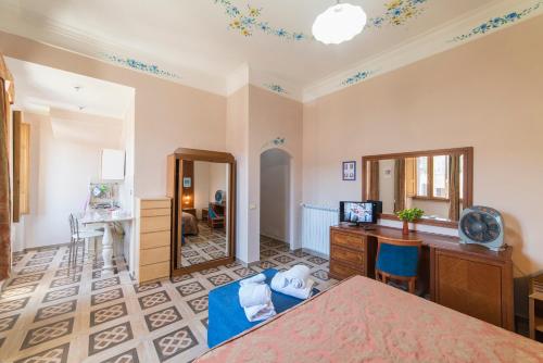 a room with a bed and a desk and a mirror at Al Seminario in Tivoli
