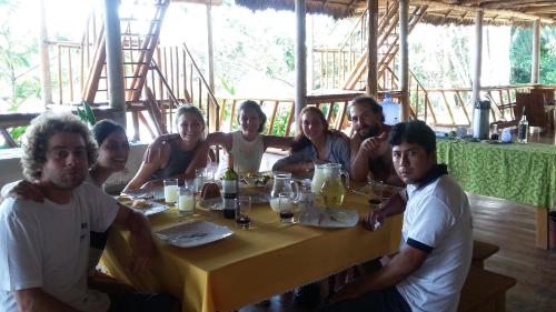 a group of people sitting around a table at Tres Chimbadas Lake Lodge in Tambopata