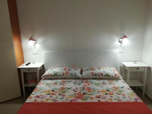 a bedroom with a bed with two night stands at Il Covo delle Civette in Vietri sul Mare