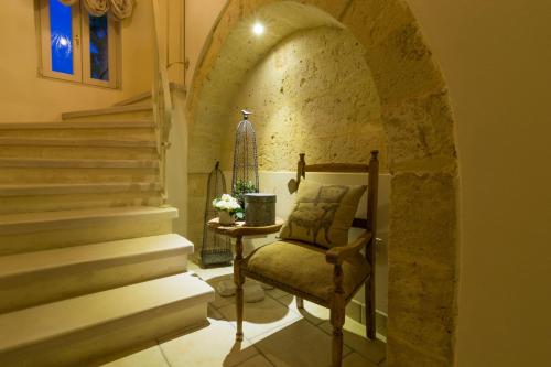 a room with a chair and stairs in a building at Masseria Sorani in Manduria