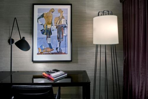 a room with a desk with a lamp and a picture at Revere Hotel Boston Common in Boston