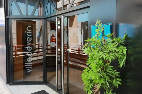 a group of glass doors in a building at Hotel Villa de Verín in Verín