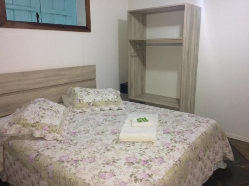 a bedroom with a bed with a towel on it at Atobá Villas in Paraty