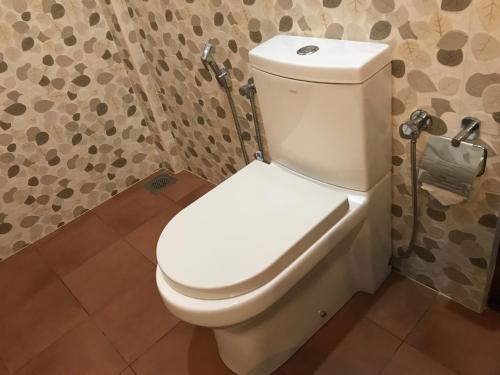 a bathroom with a white toilet in a room at Randiya Beach Villa in Galle