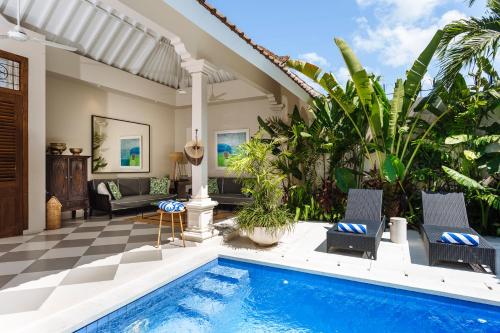 a villa with a swimming pool and a patio at Villa Alliv in Seminyak