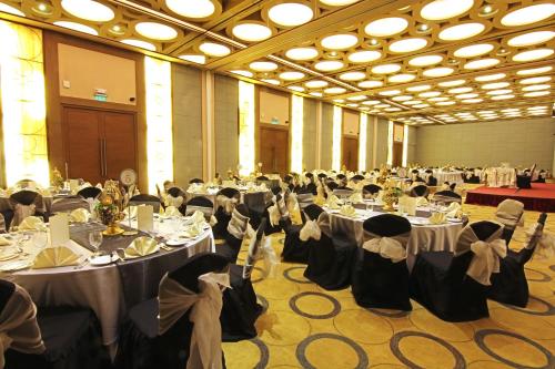 a banquet hall filled with tables and chairs with people at Luxent Hotel in Manila