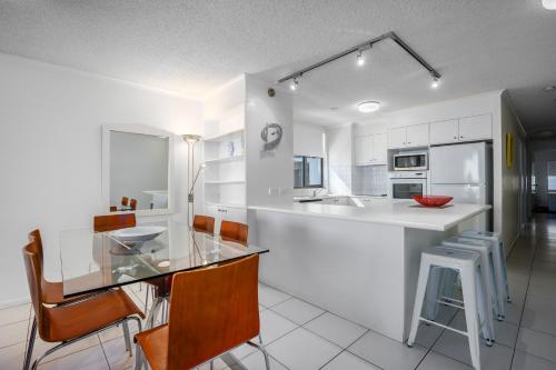 a kitchen with a sink, stove, refrigerator and dishwasher at Pacific Beach Resort in Mooloolaba