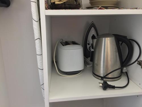 a coffee maker and a toaster on a shelf at Lithgow Valley Motel in Lithgow