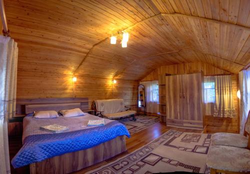 a bedroom with a bed and a wooden ceiling at EniRest in Karakol