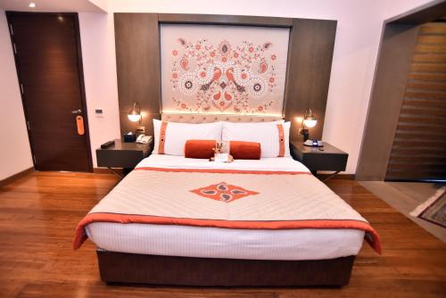 a bedroom with a large bed with two night stands at The Lalit Mangar in Faridabad