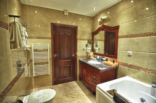 a bathroom with a sink, mirror and bathtub at Park Hotel Stara Zagora in Stara Zagora