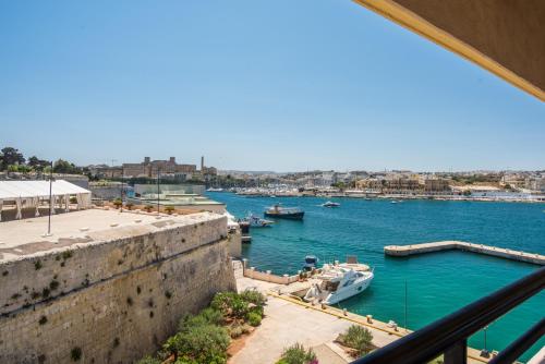 a view of a harbor with boats in the water at Grand Hotel Excelsior in Valletta