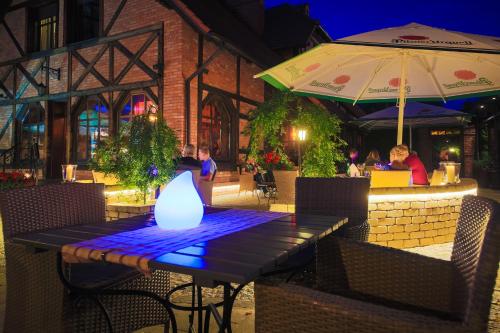a table with a lit candle on top of it at Hotel Galicja Wellness & SPA in Oświęcim