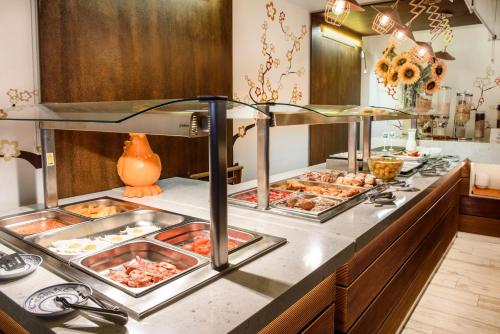 a buffet line with several trays of food at Hotel Florencio Ibiza in San Antonio