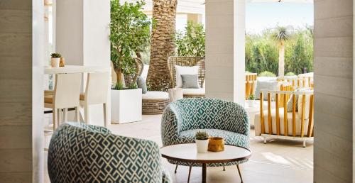 a patio with two chairs and a table at Nobu Hotel Ibiza Bay in Talamanca