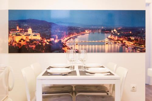 a white dining table with a view of a bridge at Bright 2BR&AC apt at Astoria in Budapest