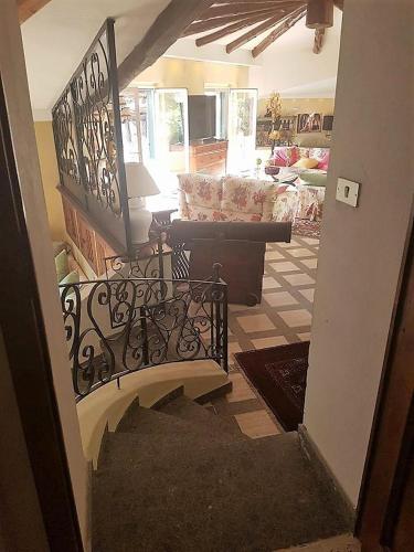a stairway leading to a living room with a couch at Residenza Villa Spagnola in Parghelia