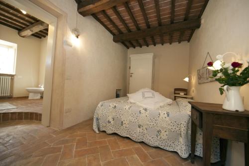 a bedroom with a bed and a vase of flowers on a table at Fonte di Zeno in Marciana