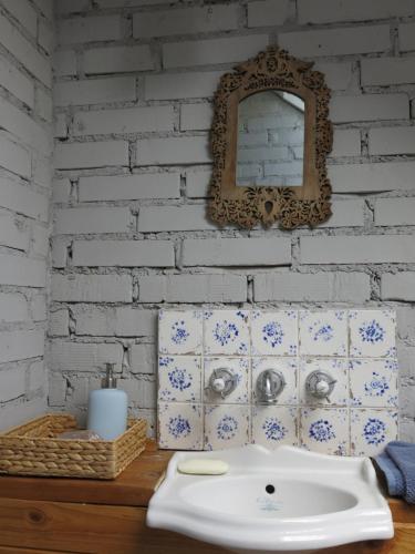 a bathroom with a sink and a white brick wall at Krzywe 3 in Krzywe