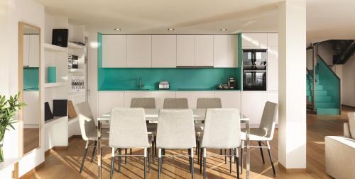 a kitchen with a dining table and chairs at Puente Romano Marbella in Marbella