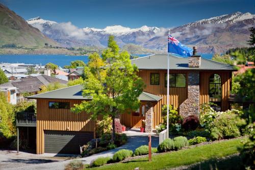a house with a flag on top of it at Wanaka Springs Lodge in Wanaka