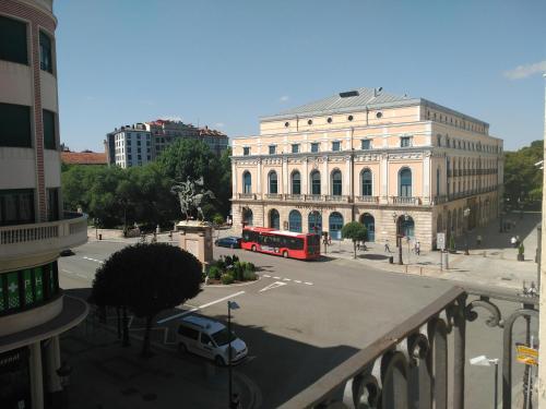 a red bus is parked in front of a building at Grand Plaza Mio Cid in Burgos