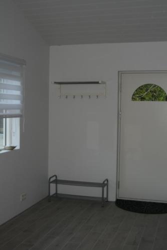 a white room with a bench and a window at Country Dream - Langholt 2 in Selfoss