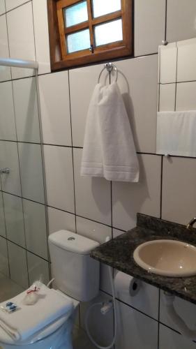 een witte badkamer met een toilet en een wastafel bij Sítio e Pousada Vista Verde in Domingos Martins
