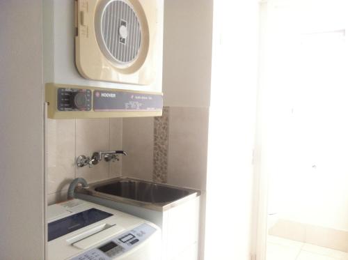a kitchen with a sink and a fan at Bayview Harbourview Apartments in Mooloolaba