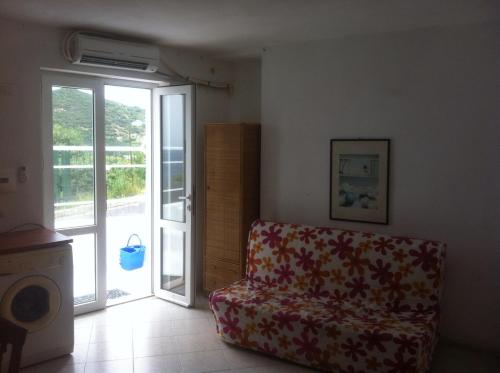a living room with a chair and a sliding glass door at Casa vacanza in Ponza