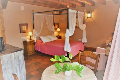 a bedroom with a bed and a table in a room at Apartamentos Lobiche in Navafría