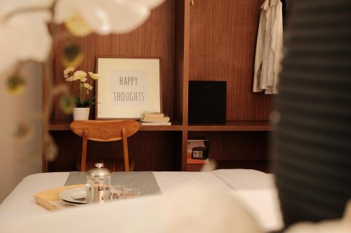 a bedroom with a table with a plate and a picture at FLAT06.Tendean in Jakarta