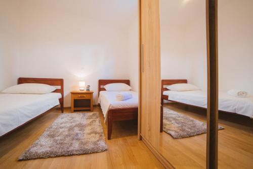 a mirror in a room with two beds at City Center LUX Apartment "TONCI" in Omiš