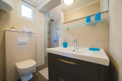 a bathroom with a sink and a toilet at City Center LUX Apartment "TONCI" in Omiš