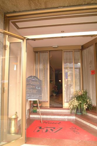 a front door of a building with a sign on it at Hotel Valentino in Perosa Argentina