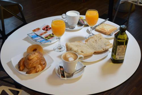 a white table topped with plates of food and drinks at Casas Reais Boutique in Santiago de Compostela