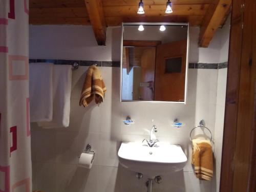a bathroom with a sink and a mirror at Chloe attic in Agia Effimia