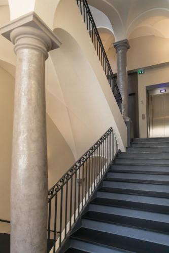 a set of stairs in a building with columns at Palais Saleya Boutique Hôtel in Nice