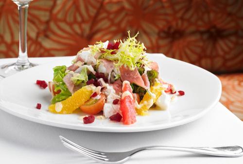 a white plate with a salad on a table at Sneem Hotel in Sneem